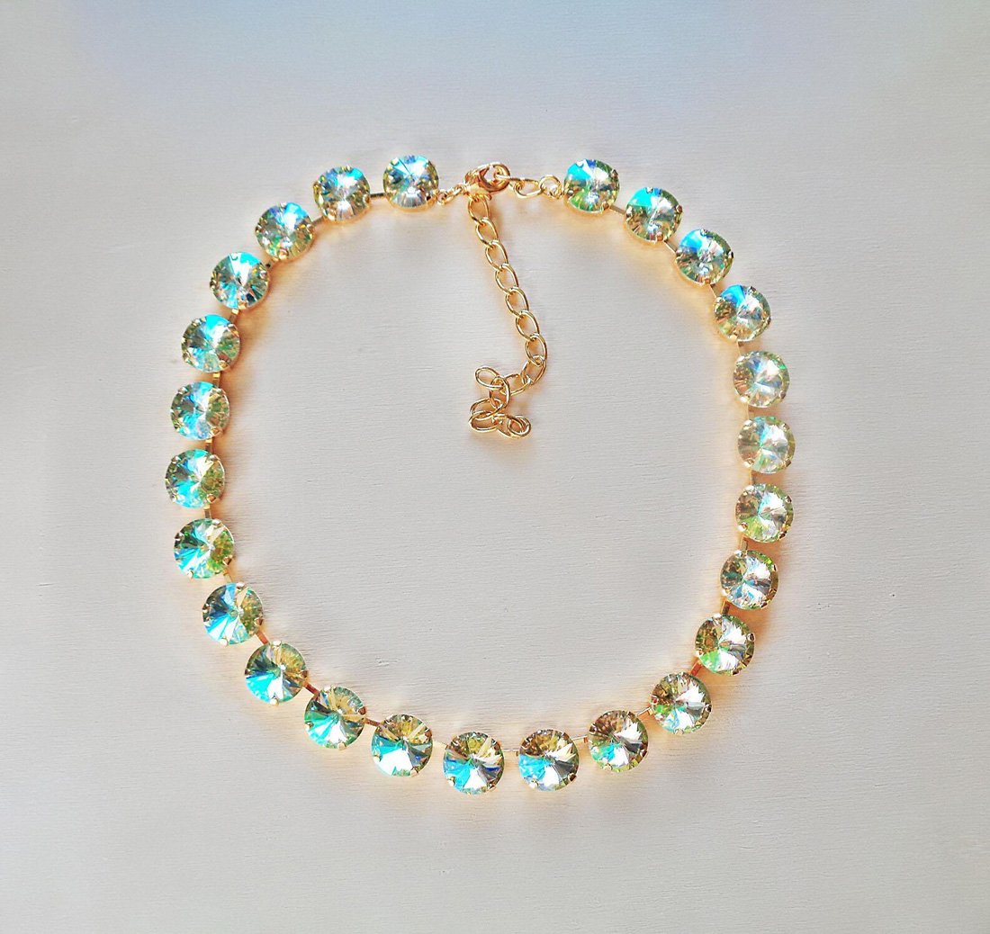 A crystal necklace made with 12mm rivoli fancy stone .It is gold plated and colour of the crystals is luminous green.Made with genuine Austrian crystals